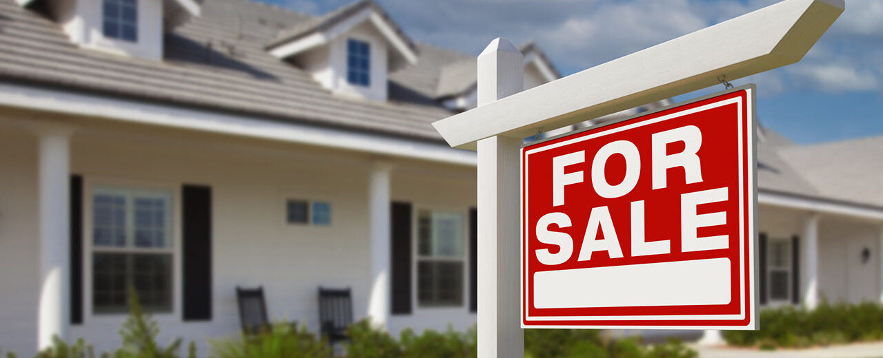 For Sale Real Estate Sign in Front of New House.