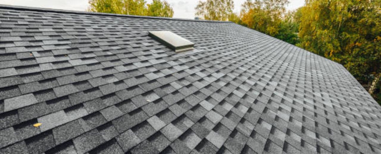 roof of new house with shingles roof-tiles and ventilation window